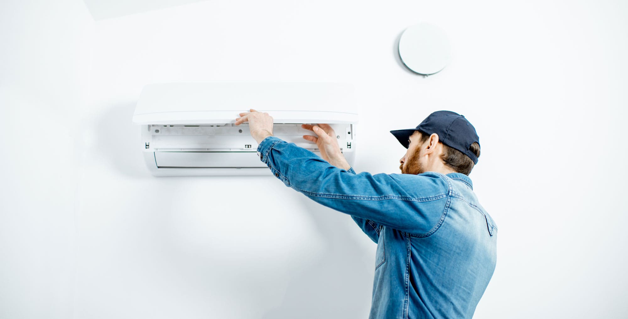 AC technician installing air conditioner